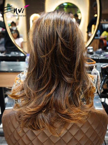 A layered cut with highlights, viewed from the chair. This shows how we build texture and dimension right from the start.