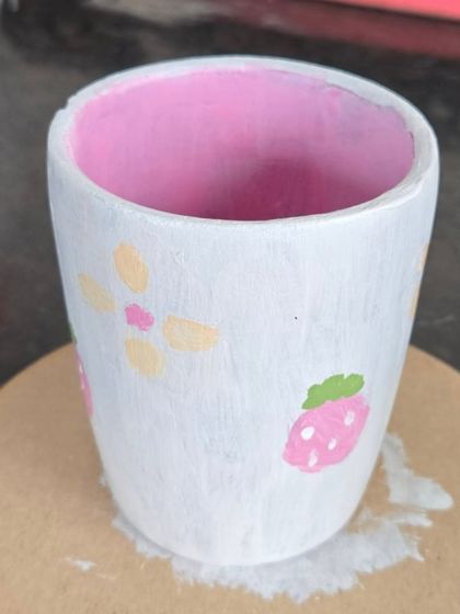 Simple, sweet, and personal. This guest painted a lovely floral and strawberry pattern on their handmade pot, creating a charming and unique piece to remember their day.