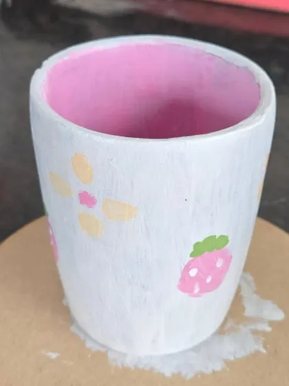 Simple, sweet, and pastel. This small pot is decorated with minimalist flowers and strawberries, showing that even simple designs can be incredibly charming.