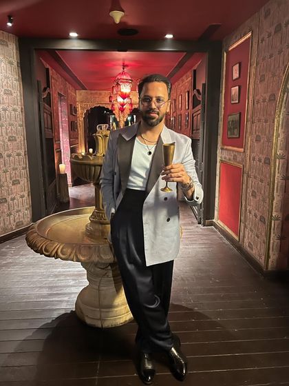 A moment of relaxation, enjoying the ambiance. My personal style often includes classic elements like a well-fitted tuxedo, reflecting a love for timeless quality.