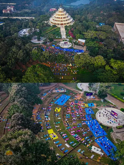 An aerial view of thousands joining an outdoor yoga session in our amphitheater. This shows the scale of our wellness events, where people connect with nature and their inner selves against the backdrop of our beautiful campus.