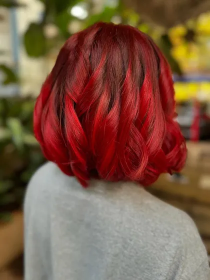 A back view of the fiery red bob, showing the depth of the color and the precision of the cut.