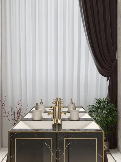 This front-on perspective of the wash basin highlights the clean lines and premium finishes. The combination of fluted wall panels, sheer curtains, and warm lighting creates a sophisticated and welcoming atmosphere for guests.