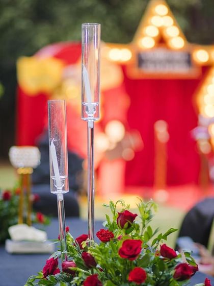 Elegant table centerpieces for the movie-themed baby shower. I used classic red roses and tall glass candle holders to add a touch of Hollywood glamour to the guest tables.