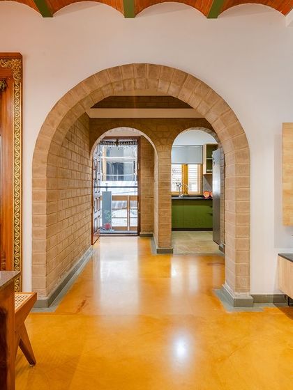 The main door to the pooja room, intricately designed, is a focal point in the dining area.