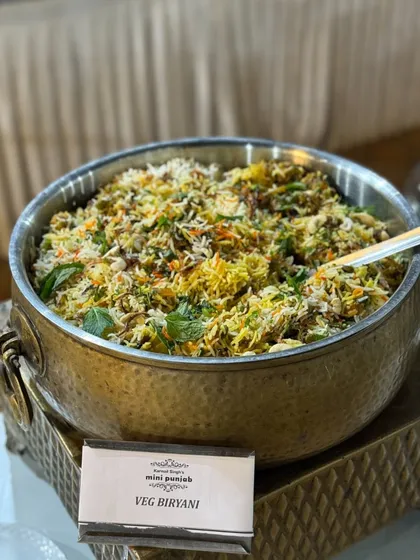 A large pot of our fragrant Veg Biryani. This one-pot meal is a celebration of aromatic spices, fresh vegetables, and long-grain basmati rice.