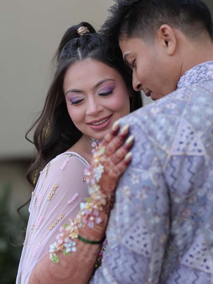 A fun and playful look for a carnival-themed event. The hair is styled in a high half-ponytail with long, voluminous curls.