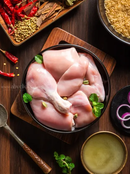 A flatlay of raw chicken and spices for Meaty Story, showcasing the fresh ingredients used in their products.