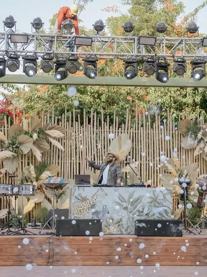 The DJ console was seamlessly integrated into the safari theme, with a custom-printed front and a backdrop of dried pampas grass and bamboo.