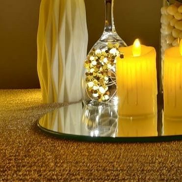 We use reflective surfaces like this small mirror to amplify the warm glow of our LED candles. This simple technique enhances the romantic ambiance and adds a layer of sophistication to the tablescape.