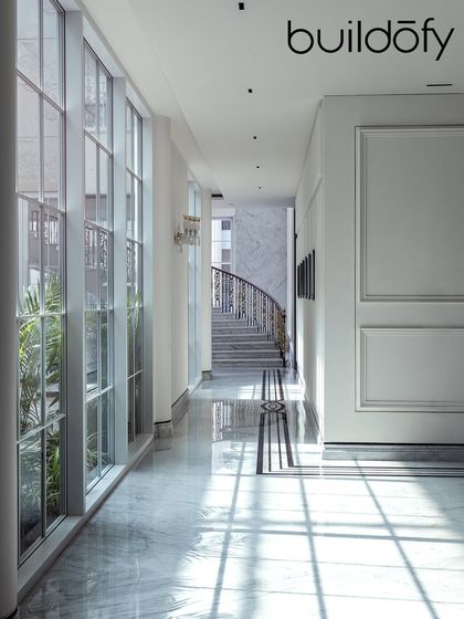 Featured in Buildofy, this corridor in The Grand Alabaster showcases the interplay of light and shadow on the polished marble floors. The classical wall mouldings and large windows create a path that is both elegant and filled with natural light.