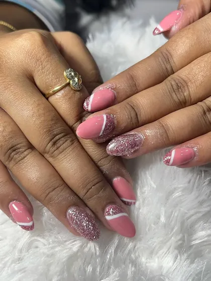 A full view of the hands with this stylish acrylic extension set. The combination of solid color, glitter, and line art makes for a very dynamic and interesting manicure.