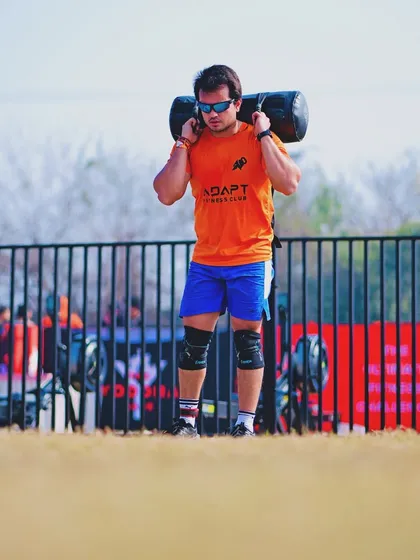 Carrying a heavy sandbag at The Yoddha Race. This is a test of functional, real-world strength. We build this kind of carrying capacity in our training.
