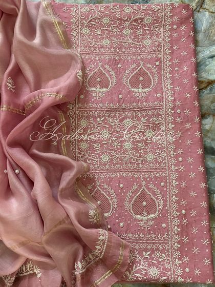 A full flat-lay on a marble background, providing a luxurious context for this beautiful pink ensemble.