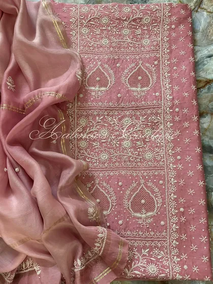 A full flat-lay on a marble background, providing a luxurious context for this beautiful pink ensemble.