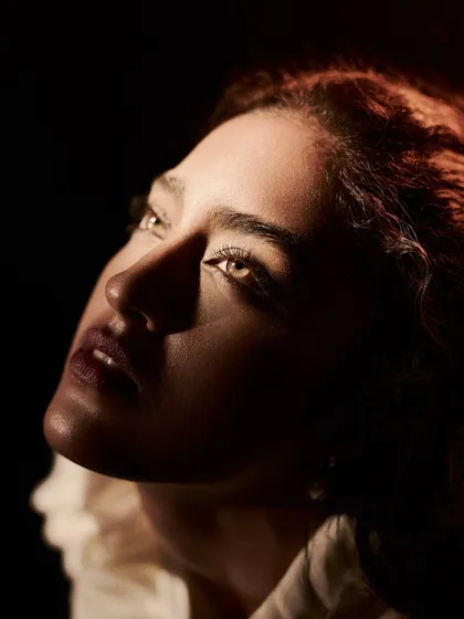 A close-up portrait from the 'Velvet Shadows' series, where I used a single, focused light source to sculpt the model's face. The technique, known as Rembrandt lighting, creates a painterly effect that highlights her expression and the subtle glow of her skin.