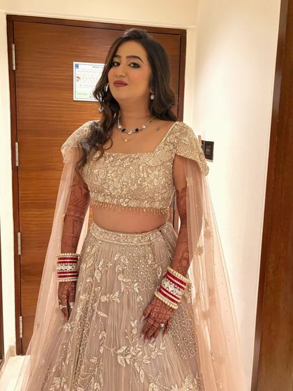 Another portrait of the bride, looking confident and happy. The soft curls and elegant makeup are perfect for her reception night.