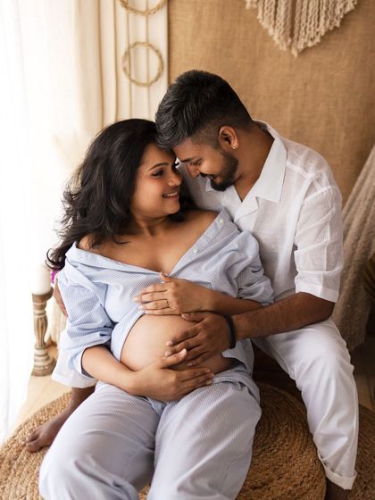 An intimate gaze between partners, capturing the deep bond they share as they await their baby.