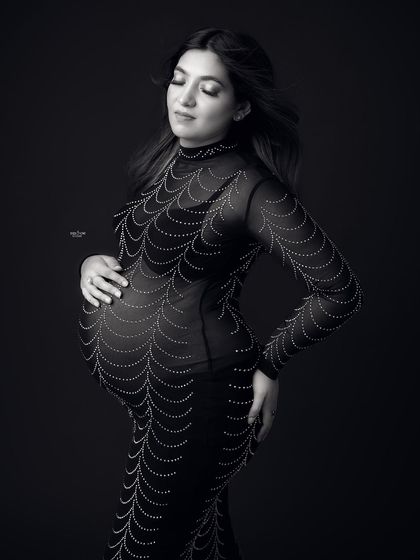 A black and white portrait that feels so timeless. The focus is on the mamma's peaceful expression and the beautiful shape of her baby bump.