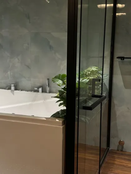 The view from the shower, looking out at the bathtub and plant. Our designs consider every angle to ensure a beautiful and immersive experience.