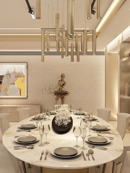 An oval dining table is seamlessly integrated into the living space of this Pune residence. The design uses a hushed palette, rich wood, and tactile finishes to create a serene sanctum that is both cozy and stately, with a sculptural light fixture adding a modern touch.