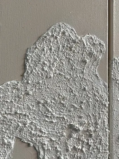 A macro shot of the rough, concrete-like texture I create as a base for my gold leaf artworks. The texture itself is a key part of the design.