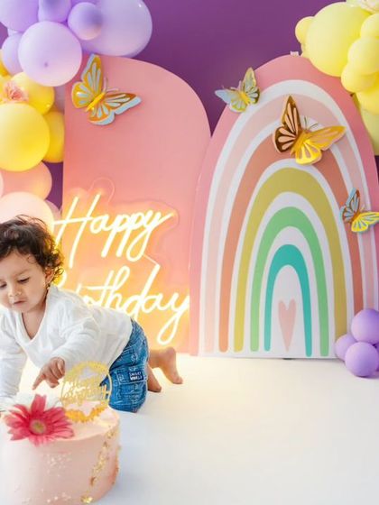 A candid moment of the baby crawling towards her cake, full of anticipation and excitement.