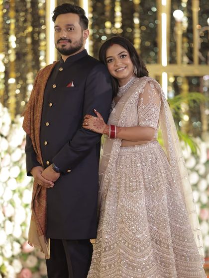 A classic couple portrait from the reception, showcasing the bride's elegant evening look.