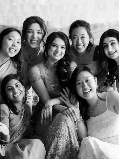 A happy black and white group photo of the bride with her multicultural group of friends at Fort Neemrana.