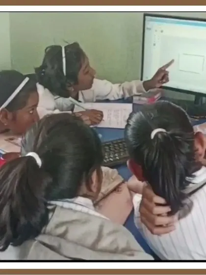 Collaboration is key to solving complex problems. Here, a group of students works together at a computer, pointing to the screen as they debug their code and figure out the logic for their project.