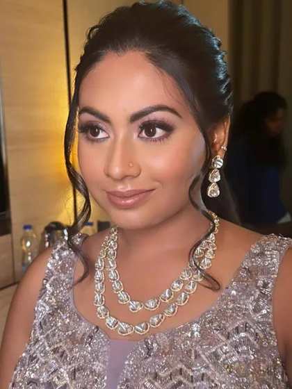 A soft glam look for an evening event. The lavender and silver tones of her outfit are reflected in the shimmery, cool-toned eye makeup.
