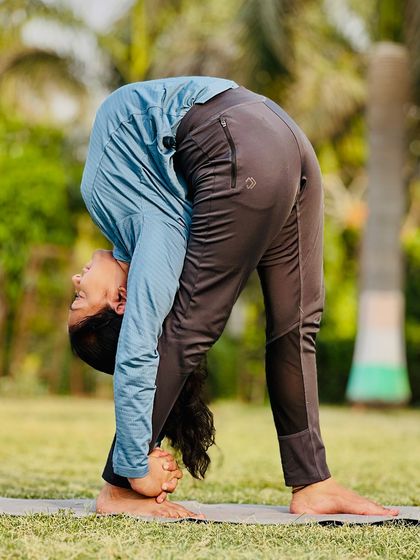 The Mahakarnasana, or great ear pose, is an intense forward fold that requires a flexible spine and open hips.