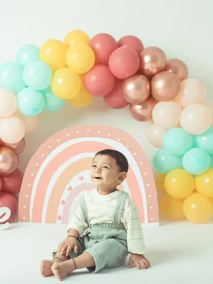 The birthday boy, part of a twin duo, enjoys his moment in the spotlight during their shared rainbow-themed shoot.