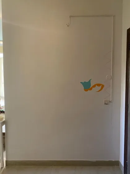 Just a few strokes of color on a blank wall, but the journey has begun. This was the very start of the 'Freedom Mural,' a project that filled this Noida home with incredible energy.