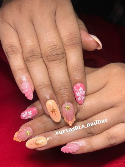 This trendy set combines multiple elements for a fun, summery vibe. It features sculpted shells, hand-painted florals, and starburst accents in a warm pink and orange color palette.