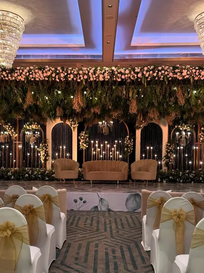 A full view of the stage with guest seating, showing how the natural, garden-like stage contrasts beautifully with the formal seating arrangement.