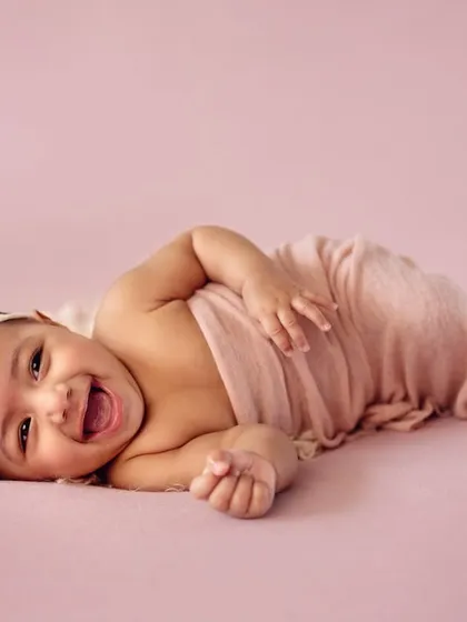 That pure, uncontainable baby laughter is the best sound in the world. This is from a 4-month milestone session, a perfect age to capture those emerging personalities and gummy smiles. We focus on simple setups that let your baby's happiness shine.