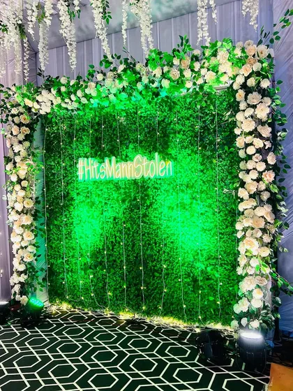 A closer look at the lush texture of the green wall and the beautifully arranged white floral border.