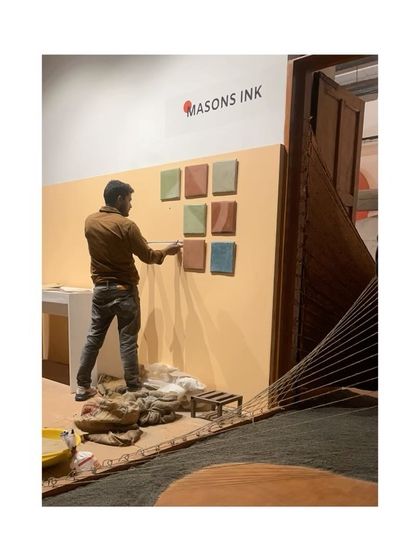 An artisan setting up the Tadelakt tile display at our IAADB exhibit. The entire process, from creation to curation, was a collaborative and exciting effort.