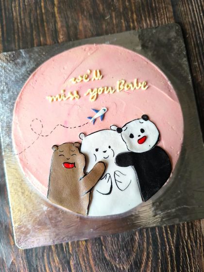 A farewell cake featuring the adorable trio from "We Bare Bears." This hand-painted design is a sweet and heartfelt way to say "we'll miss you."
