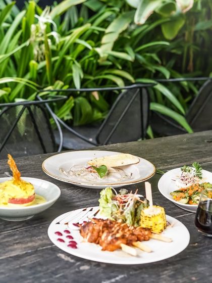 A meal set against the lush green backdrop of our garden. Dining here is an experience for all the senses.