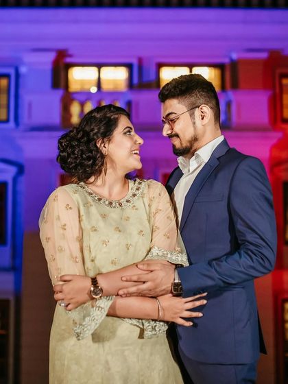 An evening shot with colorful lighting. The makeup is designed to look great in different lighting conditions, with a focus on a flawless base.