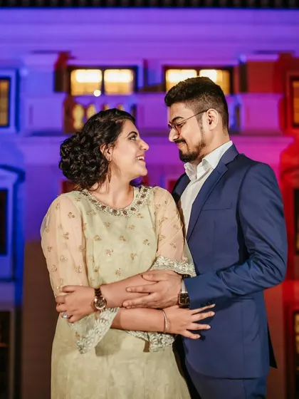An evening shot with colorful lighting. The makeup is designed to look great in different lighting conditions, with a focus on a flawless base.