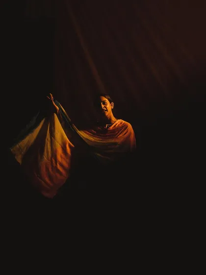 A single performer is caught in a dramatic shaft of light during a theatrical play about the Jallianwala Bagh massacre. This image shows my love for using light and shadow to create powerful, emotional, and movie-like scenes.