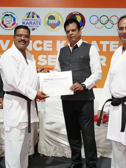 Presenting a certificate to a senior karateka at the Pune seminar. Continuous learning is key, and our advanced seminars are designed for coaches and experienced athletes to refine their skills.