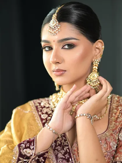 Another angle of this elegant bridal look, showing the beautiful details of the jewelry and the flawless makeup application.