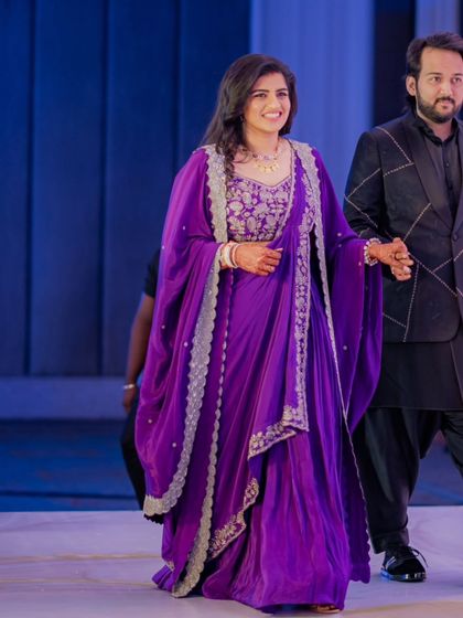 For a formal reception, we decided to customize this beautiful purple draped outfit. The lightweight fabric and elegant drapes were designed to flatter the bride's body type while allowing her to move comfortably.
