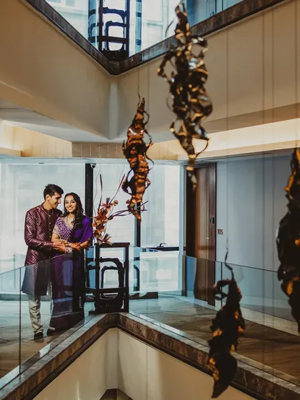 A wide-angle shot that uses the modern architecture of the space to frame the couple. This type of environmental portrait tells a story about the location as well as the couple's love.