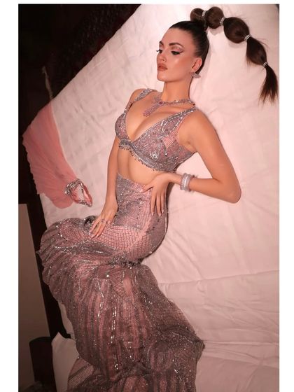 A full shot of the "Pink Barbie" look, showcasing the mermaid-style skirt and dramatic pose. This is for the bride who wants to feel like she's on the cover of a magazine.