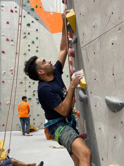 Climbing is always better with friends. Here, a climber gets ready for his route while his buddy waits to belay.